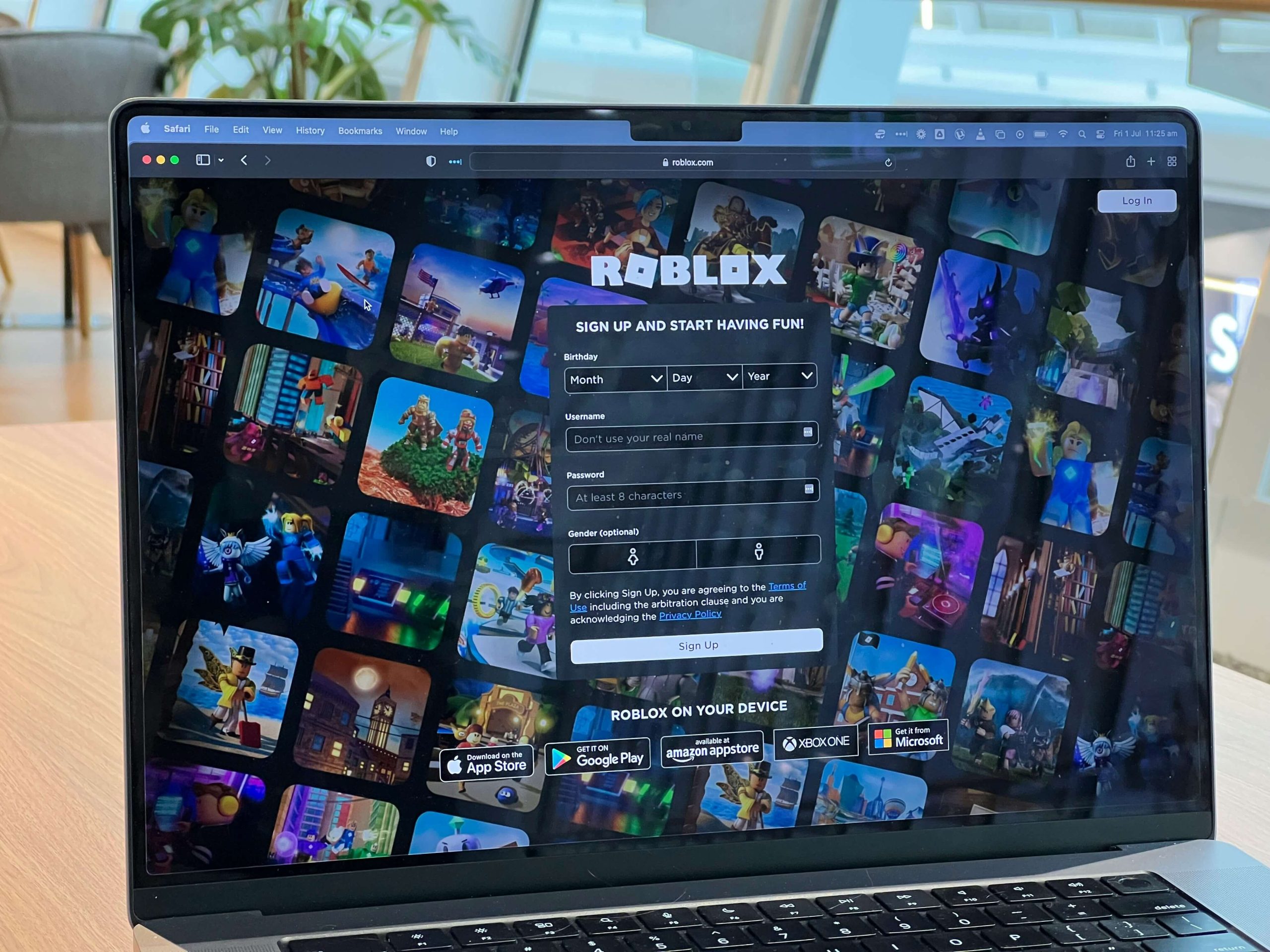 a laptop on a desk with a roblox login screen on the screen