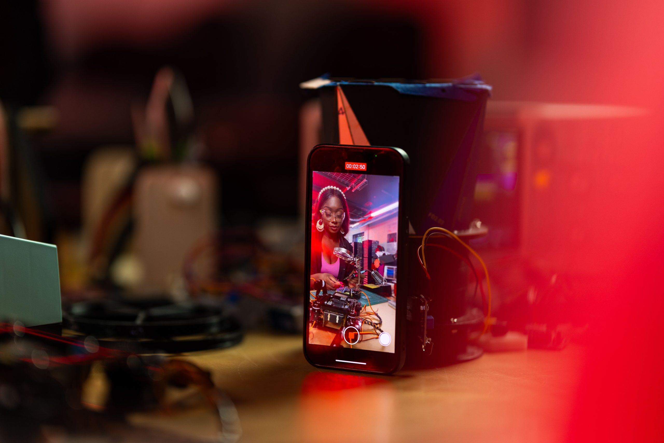 An iphone on a table that is recording a video from the front camera.
